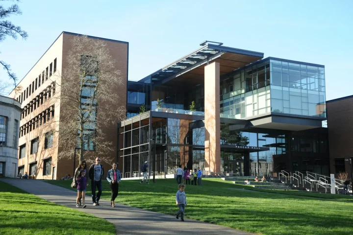 Modern glass science building with students walking