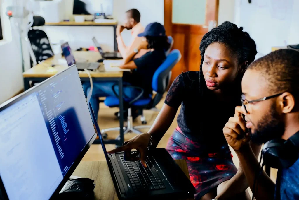 Students coding together in a computer lab