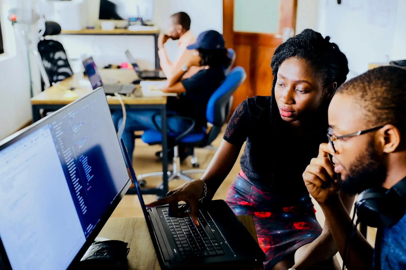 Students coding together in a computer lab