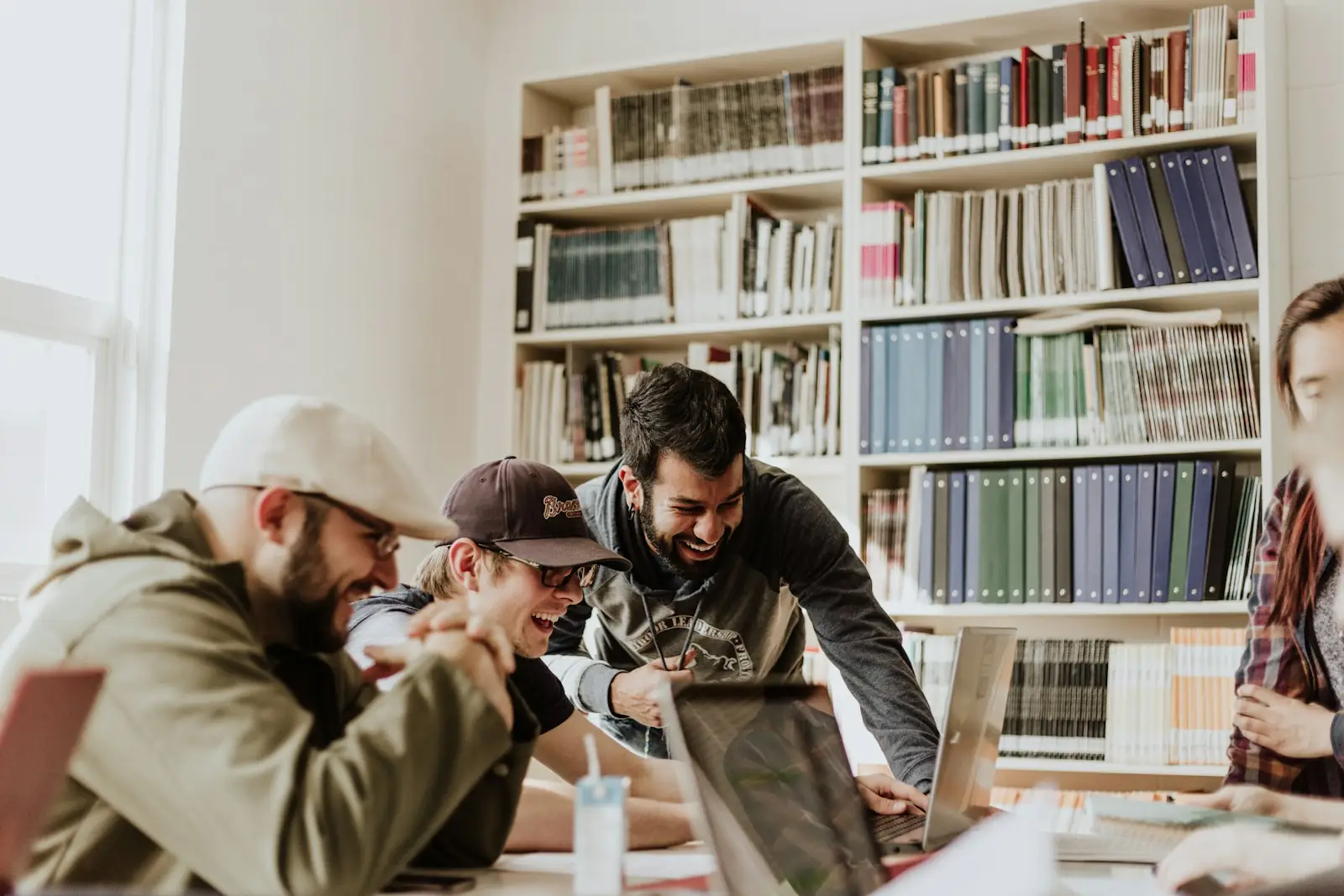 Students laughing around a table in the library